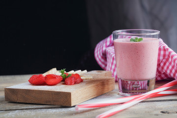 Delicious strawberry and banana smoothie or milk shake with fres