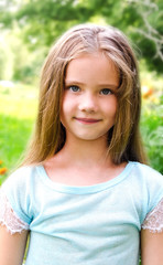 Portrait of smiling cute little girl in summer day