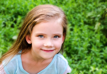 Portrait of smiling cute little girl in summer day