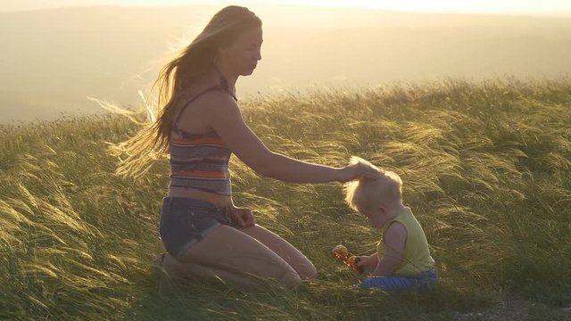 Mother and child at sunset in a meadow