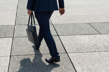 Businessman in dark blue suit is on hurry