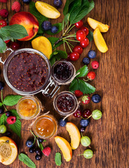 Jam made from different berries in glass jars