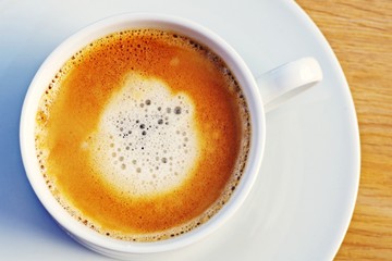 Cup of coffee. Hot coffee espresso on a wooden served table for breakfast.
