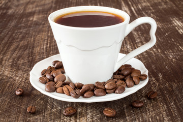 Coffee cup with roasted coffee beans.