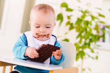Baby boy eating chocolate