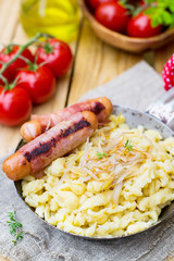 German noodles Spatzle with fried onions and sausages