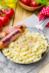 German noodles Spatzle with fried onions and sausages