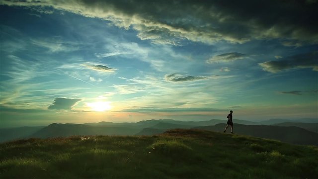 Athlete trail running in the mountains during a nice sunset. Shallow D.O.F.