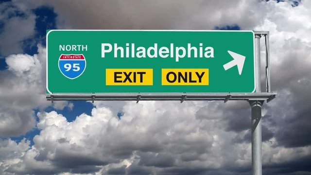 Philadelphia Interstate 95 exit only sign with time lapse clouds.