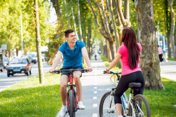 Cycling young couple.