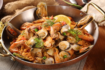 Pan of fried rice with clams, oysters and shrimps