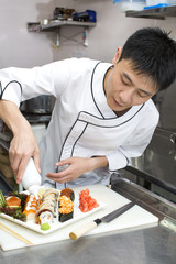Japanese chef preparing a meal in a restaurant