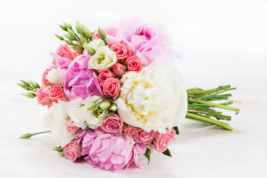 Colorful Bridal bouquet in bright colors on a white wooden table