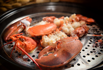 Steamed lobster with big claws on pan