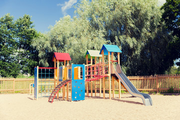 climbing frame with slide on playground at summer