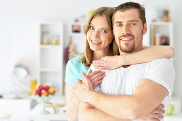 young couple standing at home