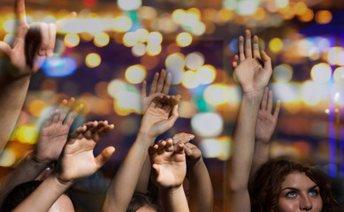 close up of happy people at concert in night club