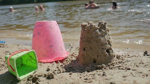 shape of sand play plastic toy house on beach near the sea resort recreation summer slow motion video