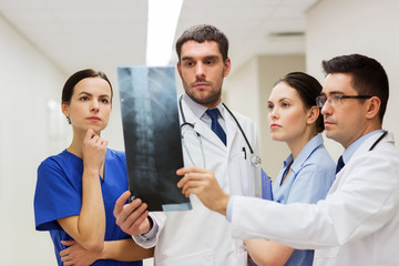 Fototapeta premium group of medics with spine x-ray scan at hospital