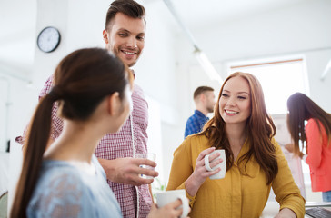 happy creative team drinking coffee at office