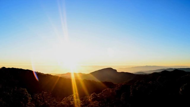 Sunrise on mountain, movement of sun at dawn, time lapse.