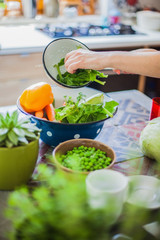 Woman cooking in kitchen with ingredients around her