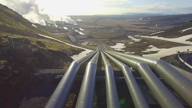 Aerial view of a geothermal power plant in Iceland. flying low over the pipeline leading hot water to the plant for power generation