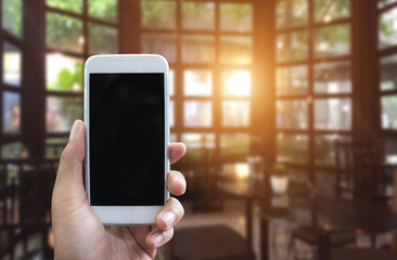 Man's hand shows mobile smartphone in vertical position