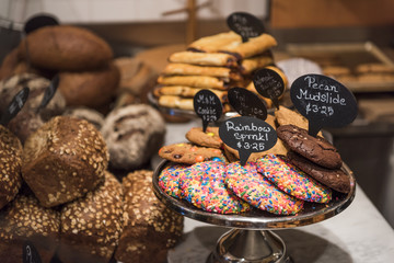 Sprinkles and Chocolate cookie display with bread in a shop