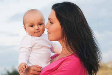 Beautiful Mother And Baby together plaingoutdoors.