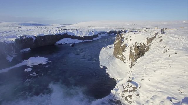 Aerial ultra high definition video of Godafoss waterfall in Iceland. Footage shot in winter with snow on the ground. Shoot with a DJI phantom pro. Drone travels downriver and over the waterfall itself