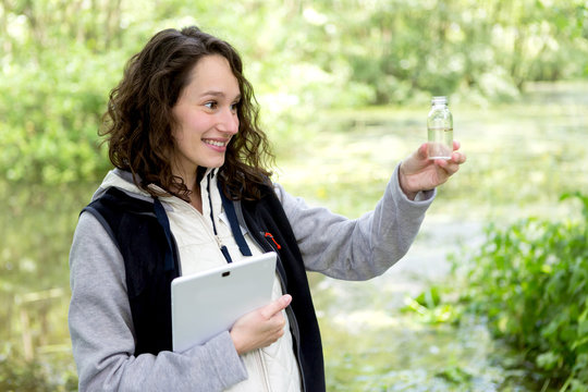 Young attractive biologist woman working on water analysis