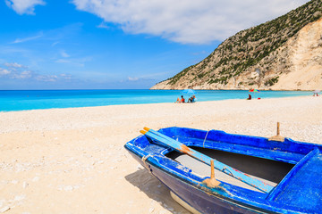 Fototapeta na wymiar Old traditional Greek blue fishing boat on Myrtos beach, Kefalonia island, Greece