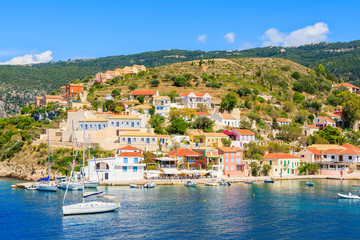 Fototapeta na wymiar Colorful houses of Assos village and yacht boats in port on Kefalonia island, Greece