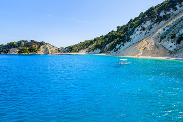 Fototapeta premium Small boat on azure sea with beautiful beach on coast of Ithaka island, Greece