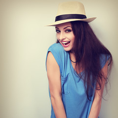 Excited joying young woman in hat looking with open mouth. Vinta