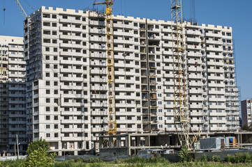 High-rise house under construction from white blocks