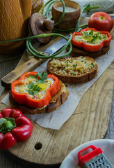 toast with cheese and meat on top of scrambled eggs with herbs