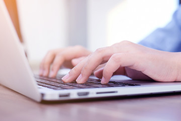 close up woman hand typing on keyboard laptop for working business