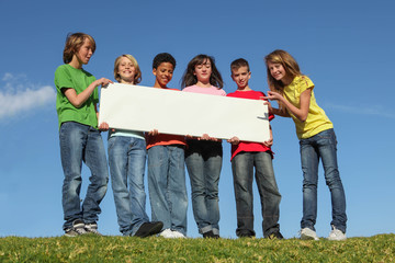 group of diversity children with white sign poster
