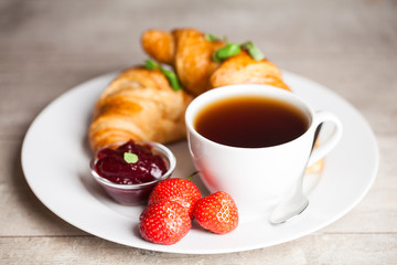 breakfast with croissants,coffee and juice on natural background