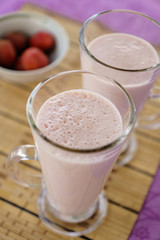 Milkshake with strawberries in a glass