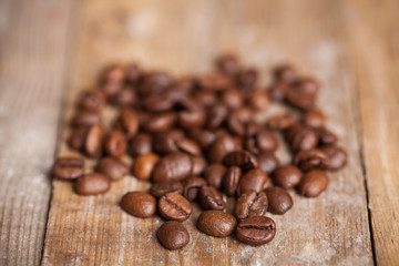 Fototapeta na wymiar Coffee beans on wood background