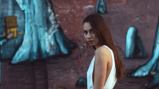 Portrait of young attractive thoughtful female at dusk. 60 FPS slow motion, 4K UHD RAW color graded footage