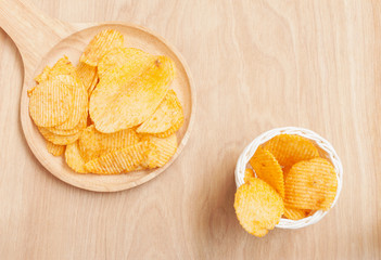Potato chips in wooden plate