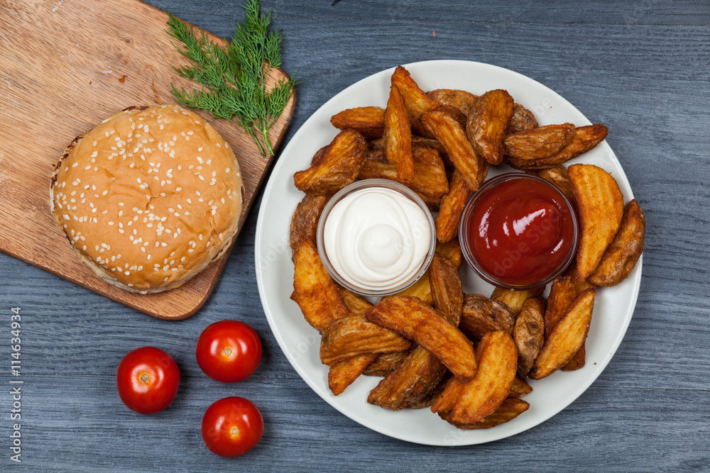 Wall mural burger with french fries on wooden background