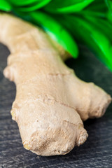 Close up of different forms of ginger against a wood worktop. Selective focus.
