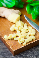 Close up of different forms of ginger against a wood worktop. Selective focus.