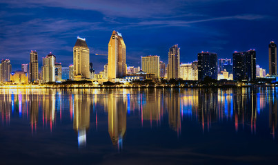 View from Coronado Island of downtown San Diego night time skyline panorama with reflections.  San...