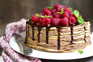 Pancake chocolate cake with fresh raspberry.